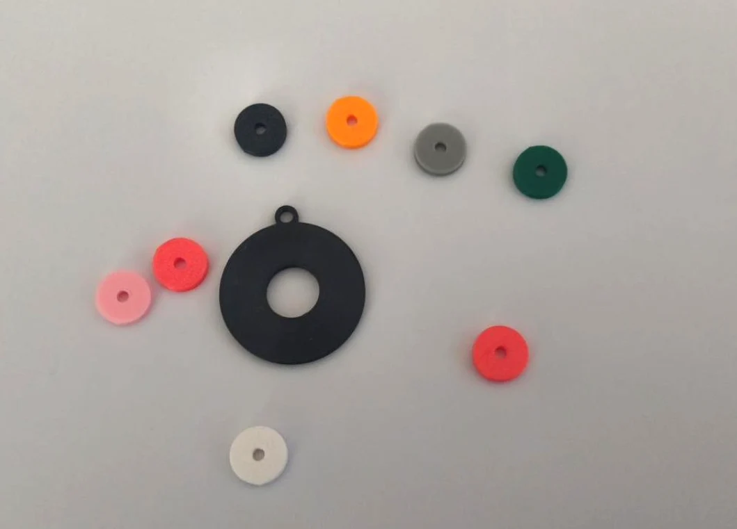 Removable record earring center inserts in different colors beside empty earring body